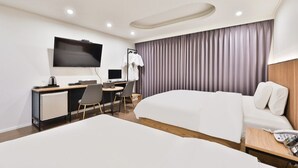 A hotel room with a bed, a desk with a computer, a TV, and a wardrobe. - Incheon BEYOND HOTEL (Incheon)
