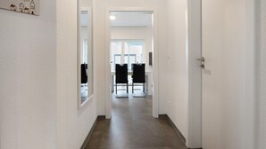 A hallway leading to a dining area with a view of the outside. - Holiday Home "Speicherhäuschen Maike" with Private Garden & Wi-Fi (Geeste)