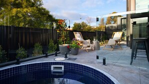 A modern outdoor pool area with a tiled pool, two lounge chairs, and potted plants. - Maison Noire- stunning Scandinavian design, great location (Daylesford)