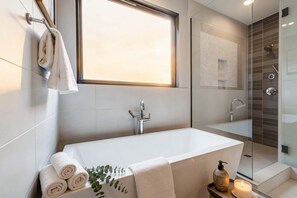 Bathtub, hair dryer, towels, shampoo