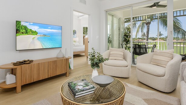 A modern living room with a large TV, comfortable seating, and a view of the outdoors. - Golf course view - Renovated luxury 3bd in Lely, resort pool, tennis, pickleball (Naples)