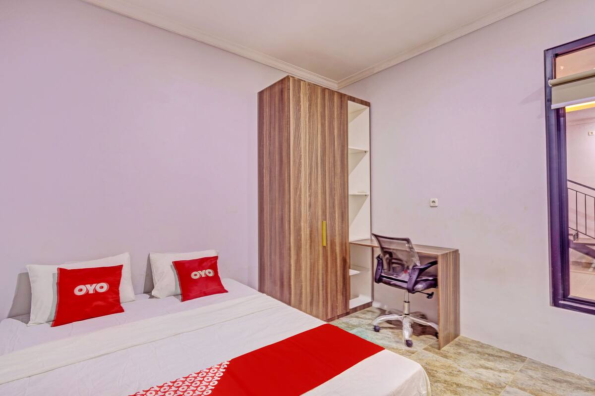 Ein Hotelzimmer mit einem Bett, einem Schreibtisch und einem Stuhl.