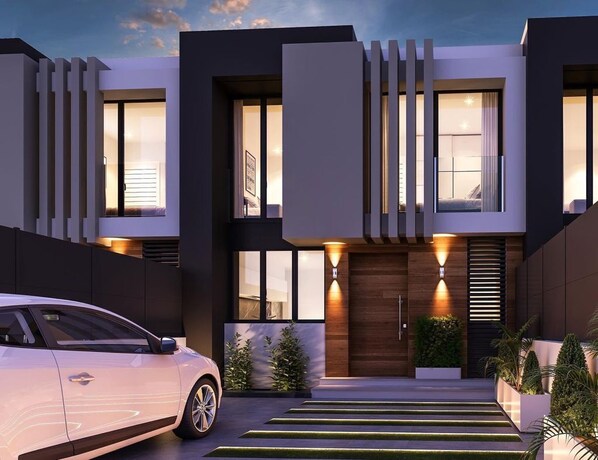 Stunning two-story home with a contemporary design, featuring a welcoming entrance and beautifully landscaped grounds.