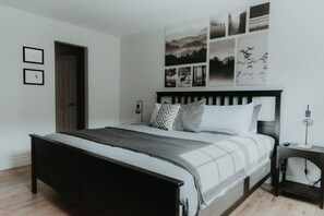 A bedroom with a bed, a bedside table, and a wall-mounted lamp. - Ski In/out Hike, Lake & Beach at Mont-Blanc (Mont-Blanc)