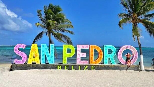 A beach sign with 'SAN PEDRO BELIZE' written in colorful letters. - Sea Horizon (San Pedro)