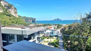 A coastal view with buildings, a clear sky, and a distant island. - Ao405 - 1 Bdr Condo With Sea View, Ao Nang Beach (Krabi)