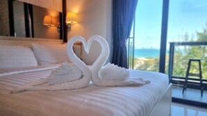 A hotel room with a bed featuring two swan-shaped towels. - Ao405 - 1 Bdr Condo With Sea View, Ao Nang Beach (Krabi)
