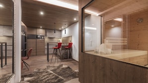 A modern kitchen with wooden cabinets, a red bar stool, and a large mirror. - Fliana Residenz (Ischgl)
