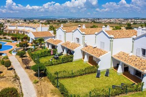 Stroll through the charming residential area, surrounded by lush green lawns and a picturesque town view.