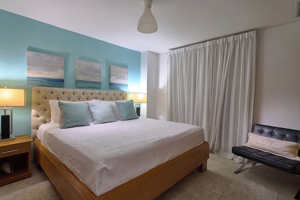 Main room with king bed, A/C, and TV for maximum comfort.