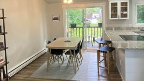 A kitchen with a dining table, chairs, a ceiling fan, and a view to the outside. - Beautifully updated home in the South Hills (Missoula)