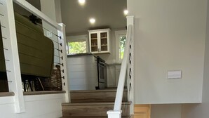 A staircase with wooden steps leading to a landing. - Beautifully updated home in the South Hills (Missoula)