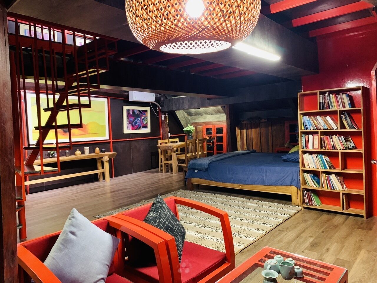 A cozy room with a bed, a bookshelf, a desk, and a chair.
