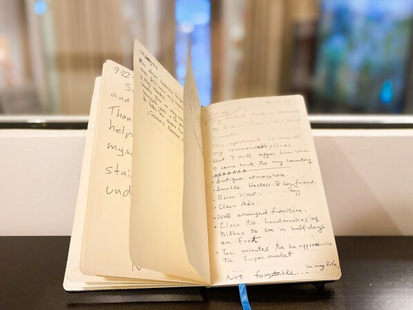 An open notebook with handwritten notes on a table. - Refugio Noruego en Bilbao (Bilbao)