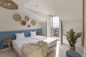 A modern bedroom with two beds, a large window, and a view of the city. - La Bere Lisbon Pra Ncipe Real (Lisbon)