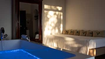 Relax in a spacious room with a modern bathroom and cozy seating area.
