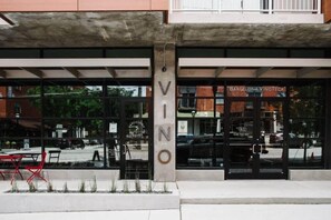 A building with a large glass facade and the name "VINO" prominently displayed. - Carmelot (Atlanta)