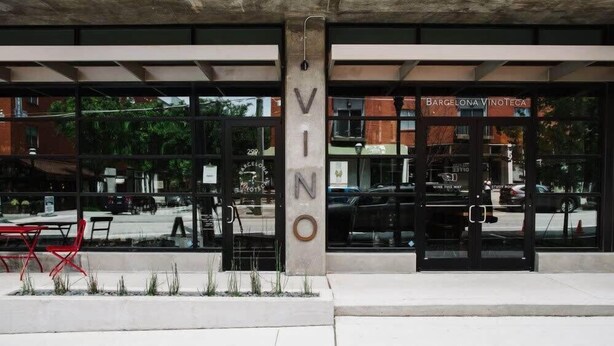 A building with a large glass facade and the name "VINO" prominently displayed. - Creme Carmel (Atlanta)