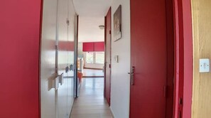 Corridors lead to rooms with a window offering a view of the outside.