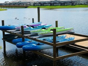 A wooden dock with several kayaks and canoes. - The Epic 32 Supreme Storey Lake Resort Orlando FL (Kissimmee)