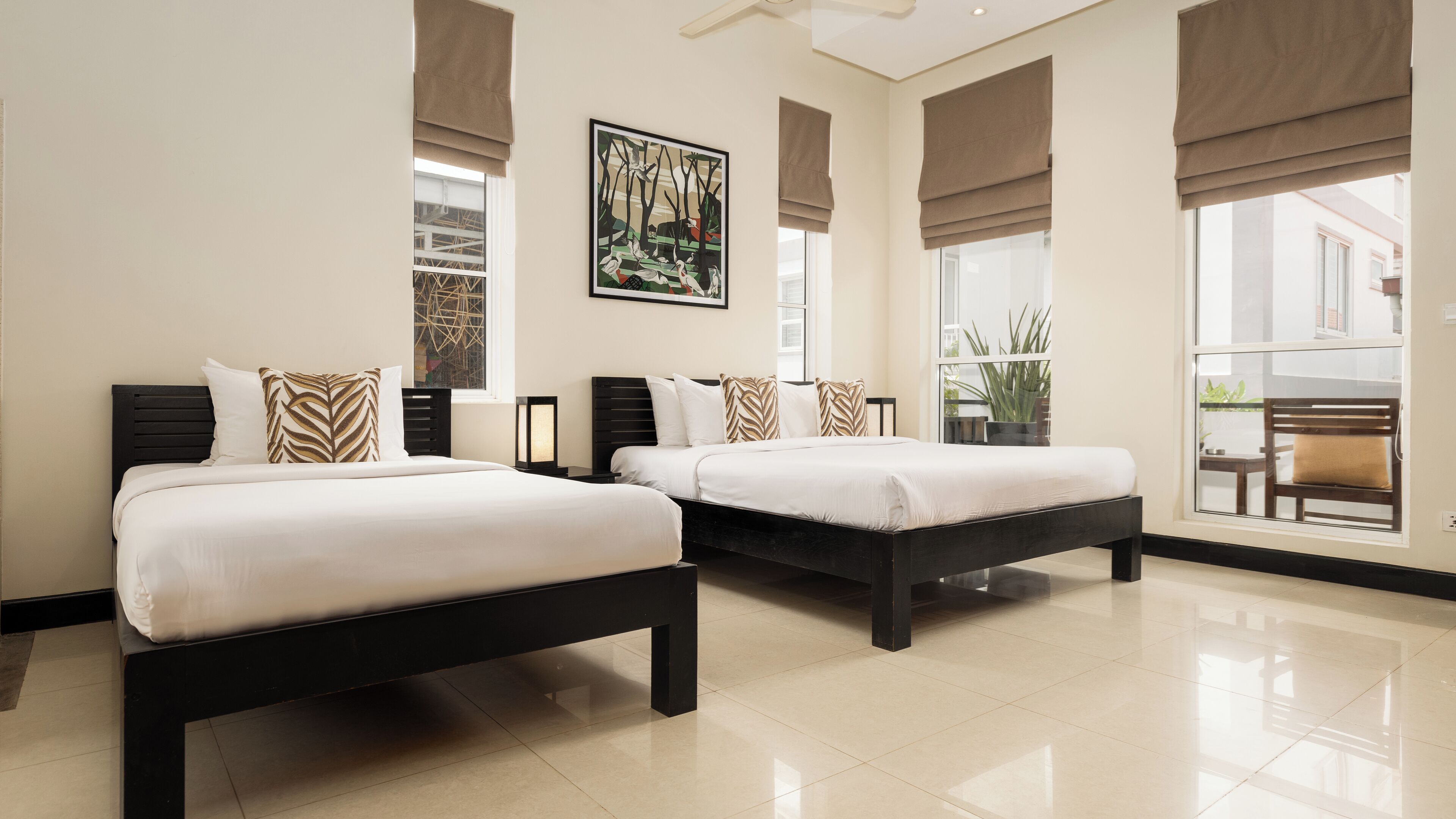 Deluxe Triple Room | Minibar, in-room safe, individually decorated, desk