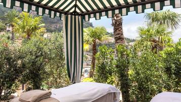 Relax in a serene outdoor space with a shaded seating area and lush greenery.