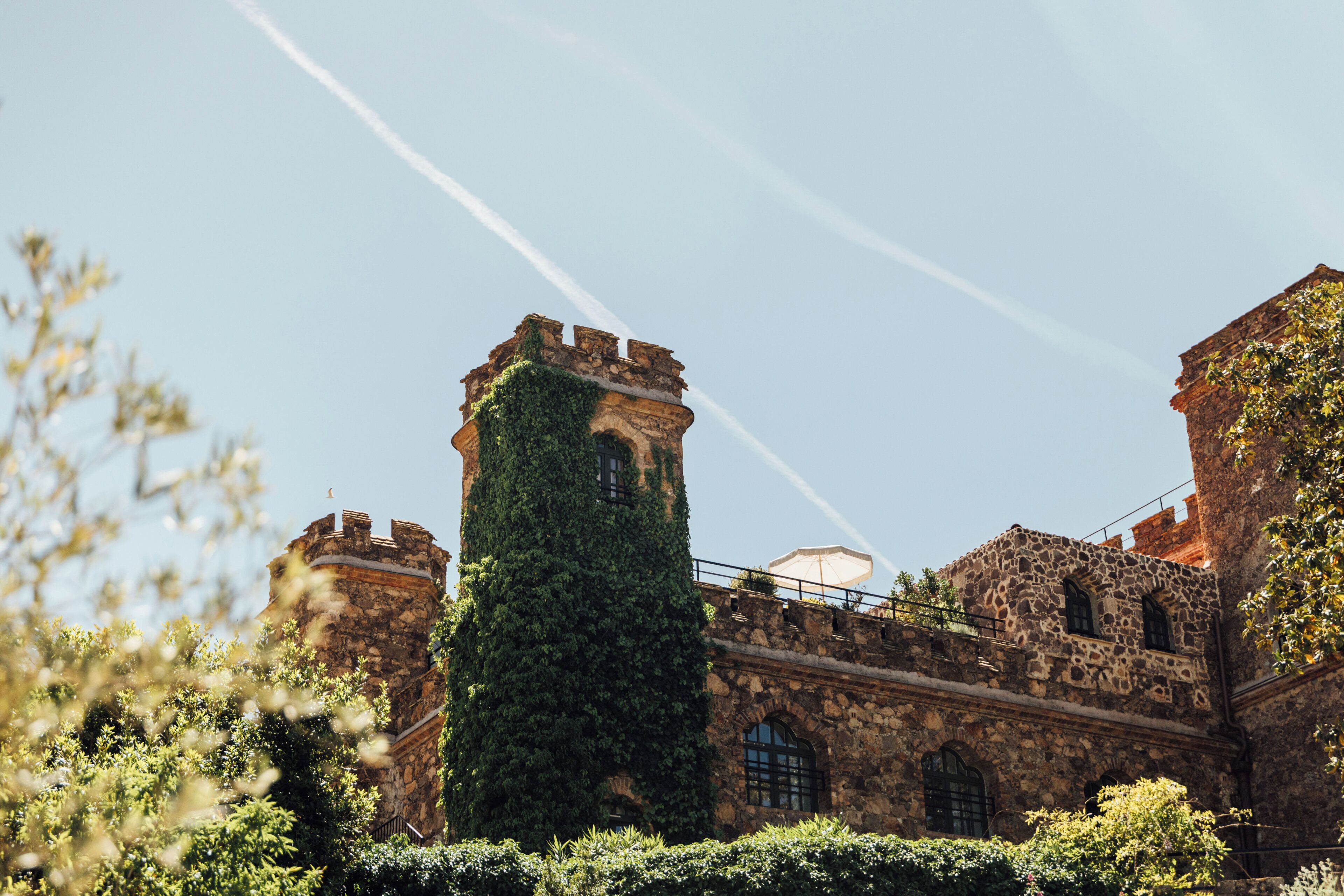 A historic building with a tower, arched windows, and stone walls.