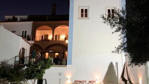A white building with a swimming pool, a covered outdoor seating area, and a staircase leading to an upper level. - Solar de Arraiolos (Arraiolos)