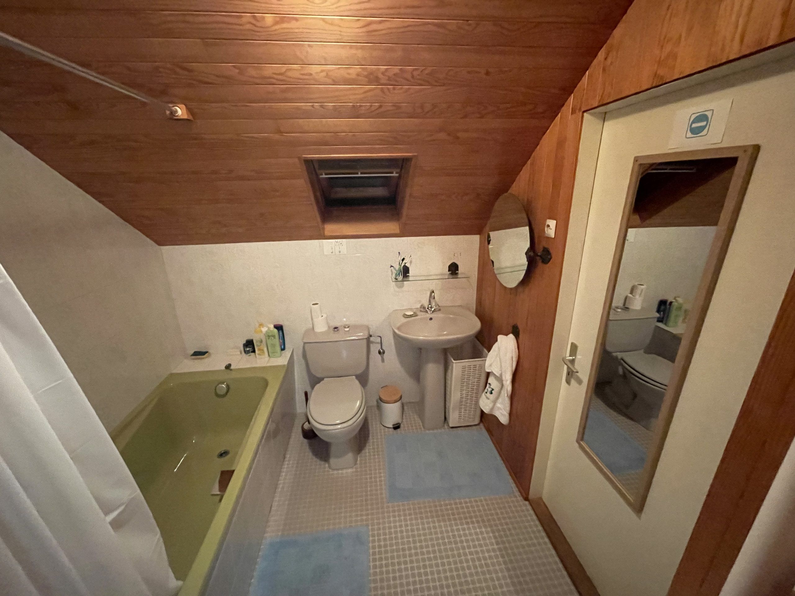 A compact bathroom with a bathtub, toilet, and sink.
