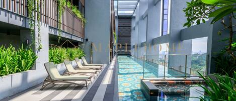 Outdoor pool, open 7:00 AM to 10:00 PM, pool loungers