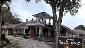 A two-story building with a balcony and a sign that reads "RESORT". - OYO 93159 Resort Cinta Kasih (Megamendung)