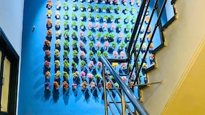 A staircase with a blue wall and a metal railing. - Qotel Comfort Chattarpur- Near Chattarpur Metro (New Delhi)