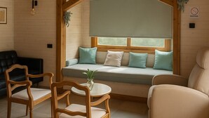 A cozy living room with a wooden bench, a sofa, and a table. - Luxury Rural Cuenca 2 (Nohales)