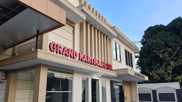 A hotel with a prominent sign reading "GRAND KARATIKA HOTEL". - Collection O 93163 Hotel Grand Kartika (Makassar)