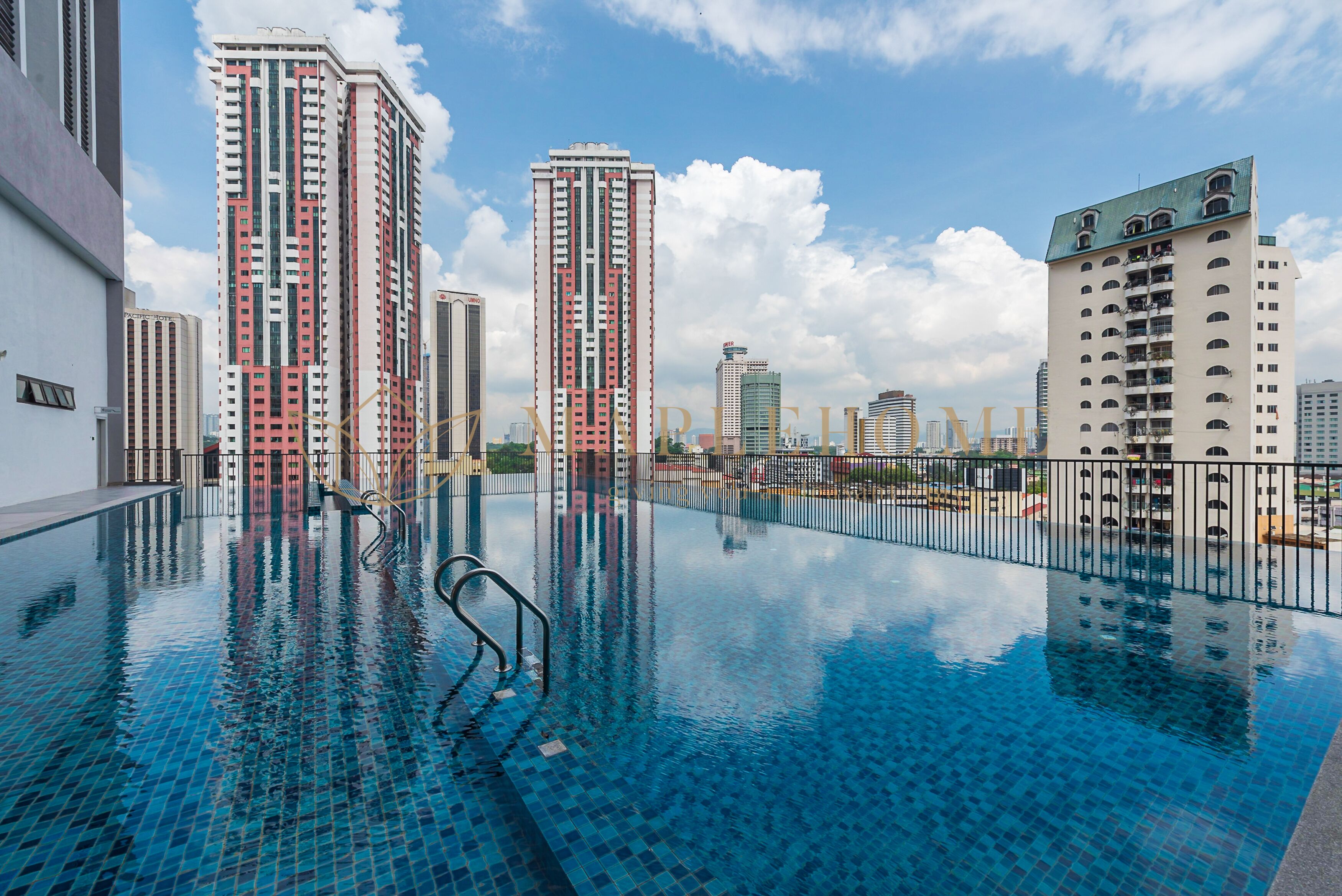 A swimming pool with a clear view of tall buildings in the background.