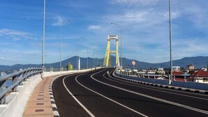 A bridge with a clear road, guardrails, and streetlights. - Hotel O Permata Ria Hotel (Manado)