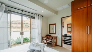 Ein Hotelzimmer mit Bett, Schreibtisch, Spiegel und Kleiderschrank.