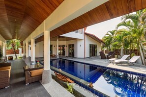 A pool area with lounge chairs, a wooden ceiling, and tropical plants. - Amber Pool Villa, Your private slice of paradise (Rawai)