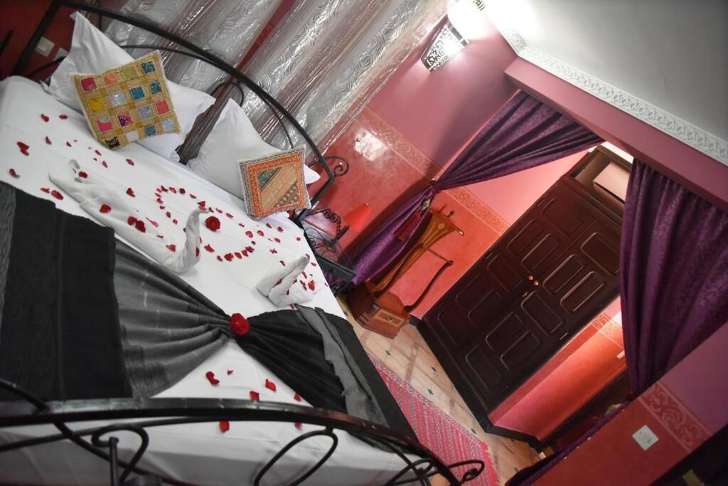 A room with a bed, a door, and a window.