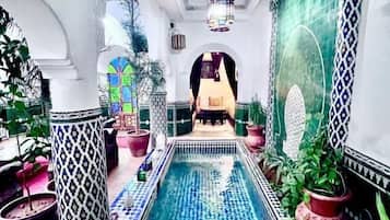 Indoor pool, pool umbrellas, sun loungers
