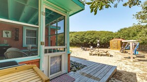A beach house with a deck, outdoor seating, and a small shed. - Oh So Sandy! - Southern Shores, Historic Flat Top, 100 Yds to Beach, Pets OK, Flex Stays (Southern Shores)