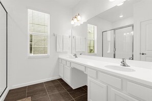 Bathtub, hair dryer, towels, shampoo