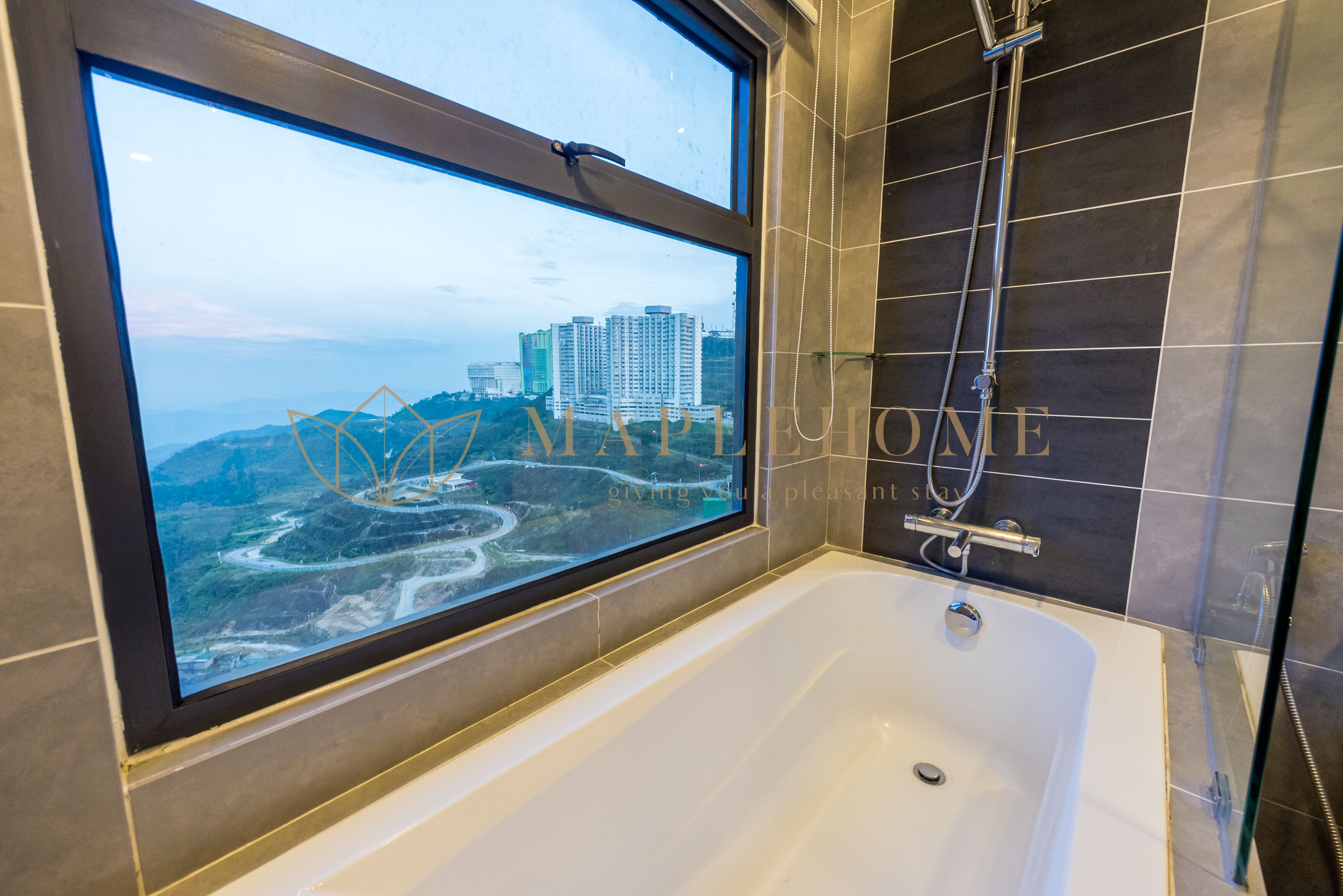 A modern bathroom with a large bathtub, a shower, and a window offering a city view.