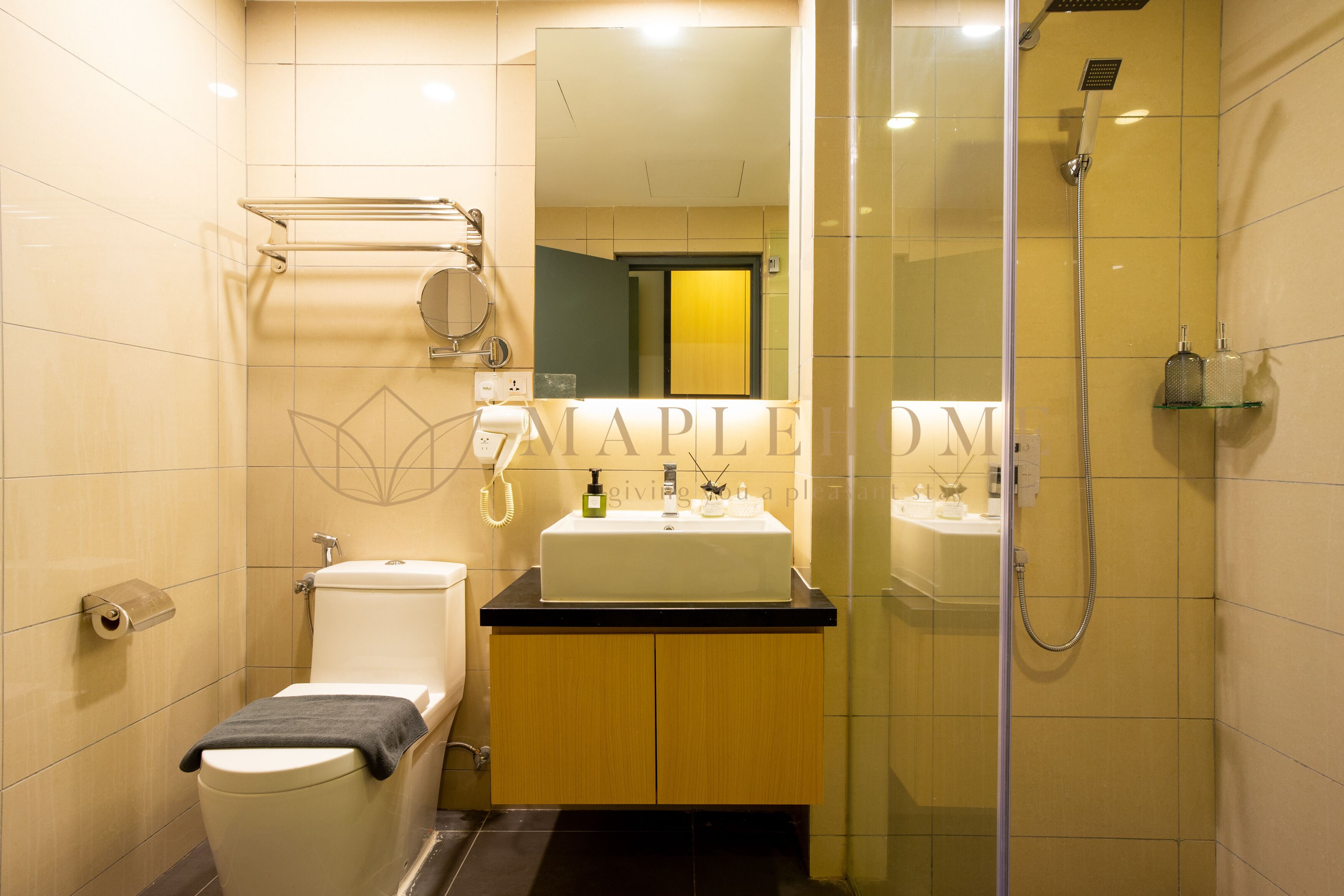 A modern bathroom with a toilet, sink, and shower.