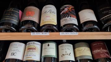 A wine rack with various bottles of Cote-Rotie wine from different years.