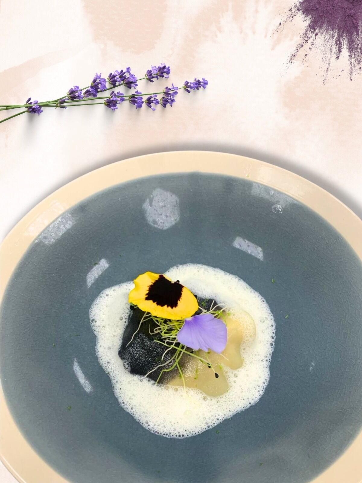 A bowl of soup with a decorative flower arrangement on top.
