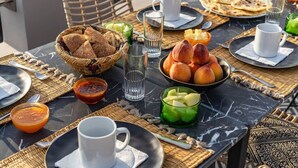 A table set with bread, peaches, and drinks, suggesting a meal setting. - Riad Princesses des Sables-Jaccuzzi-Breakfast (Marrakesh)