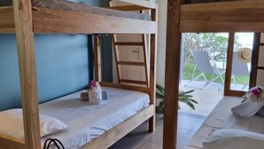 A bunk bed room with a view of the outside.