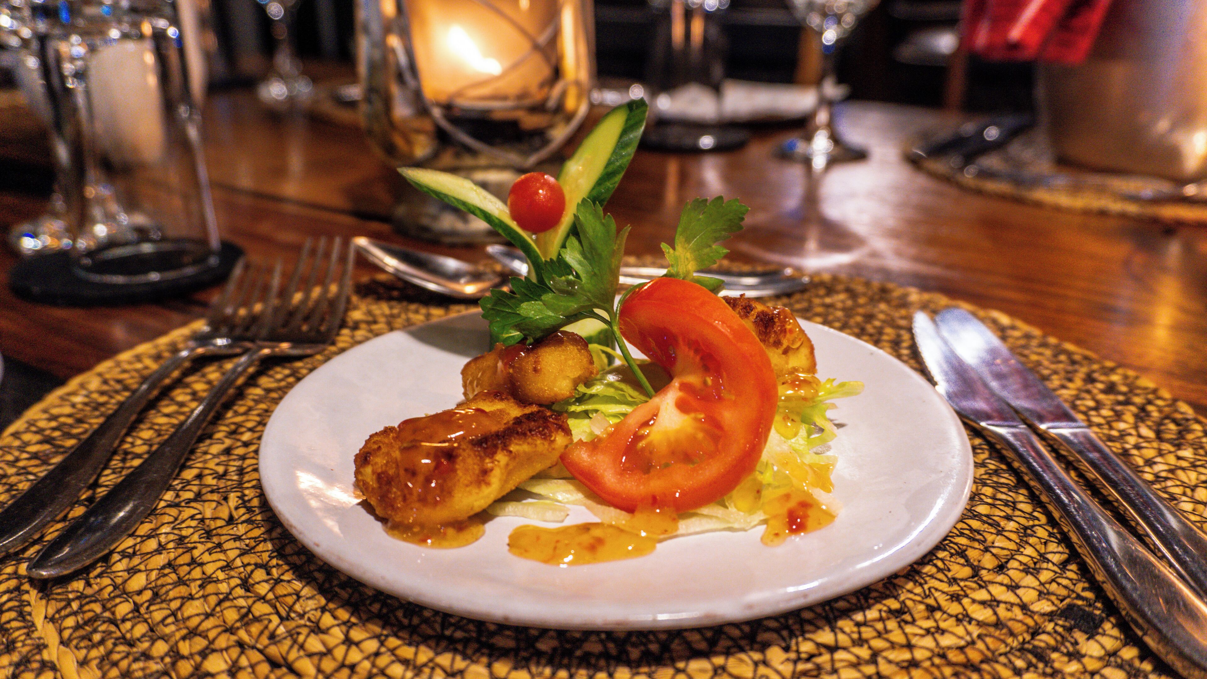 A plate of food with a fork and knife on a table.