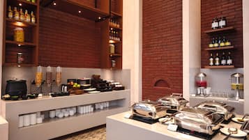 A buffet area with various food items and condiments.
